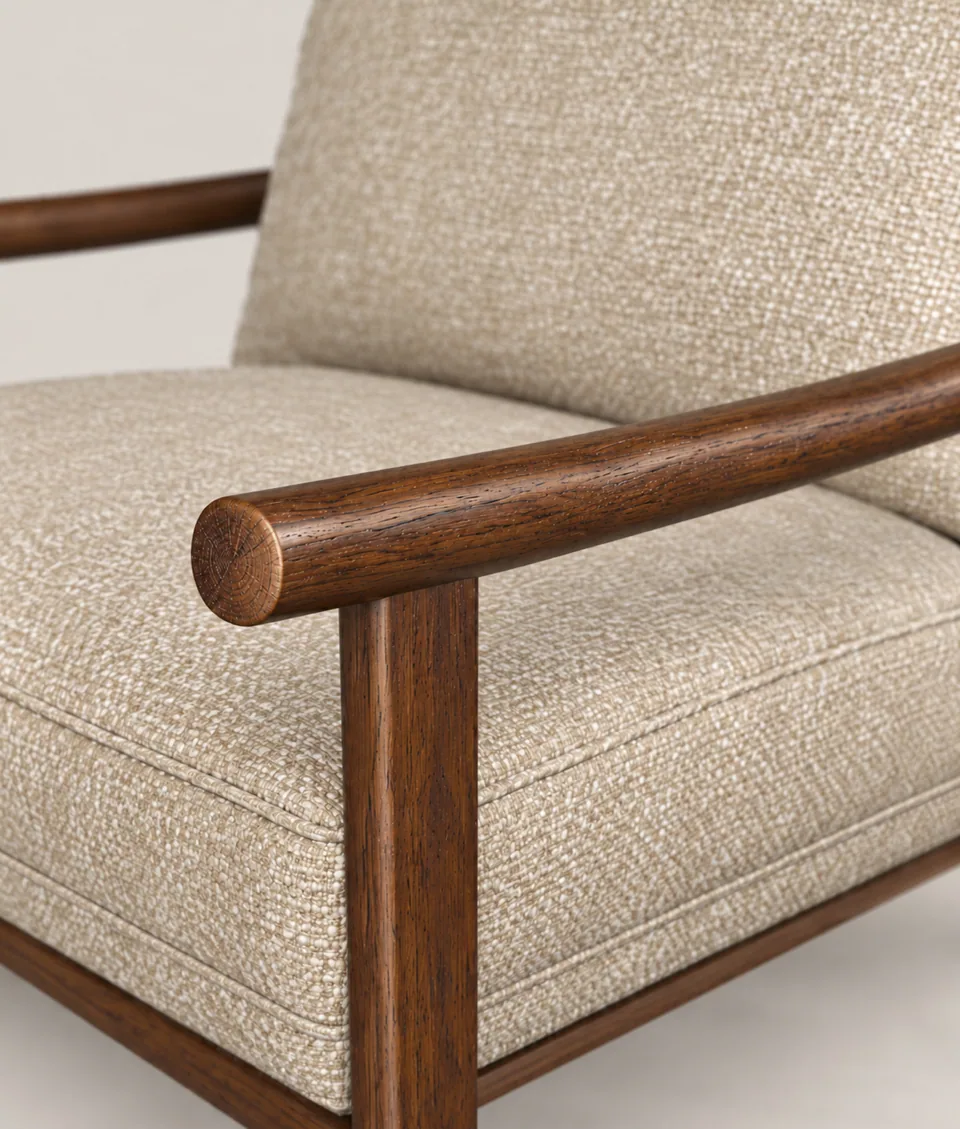 Mangeshi Arm Chair in sand bouclé with a dark-stained oak frame, close-up of the rounded oak arm tip and front leg joint
