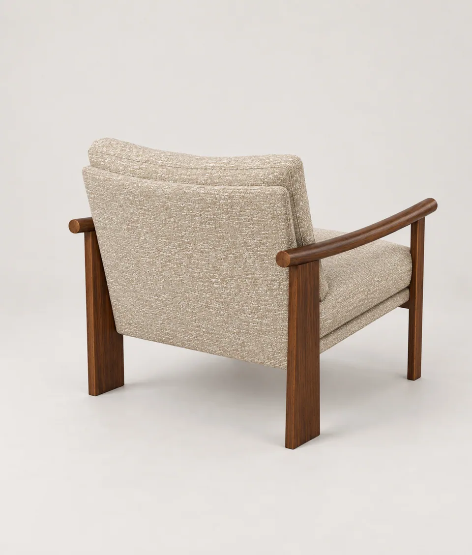 Mangeshi Arm Chair in sand bouclé with a dark-stained oak frame, rear three-quarter view showing the upholstered back panel