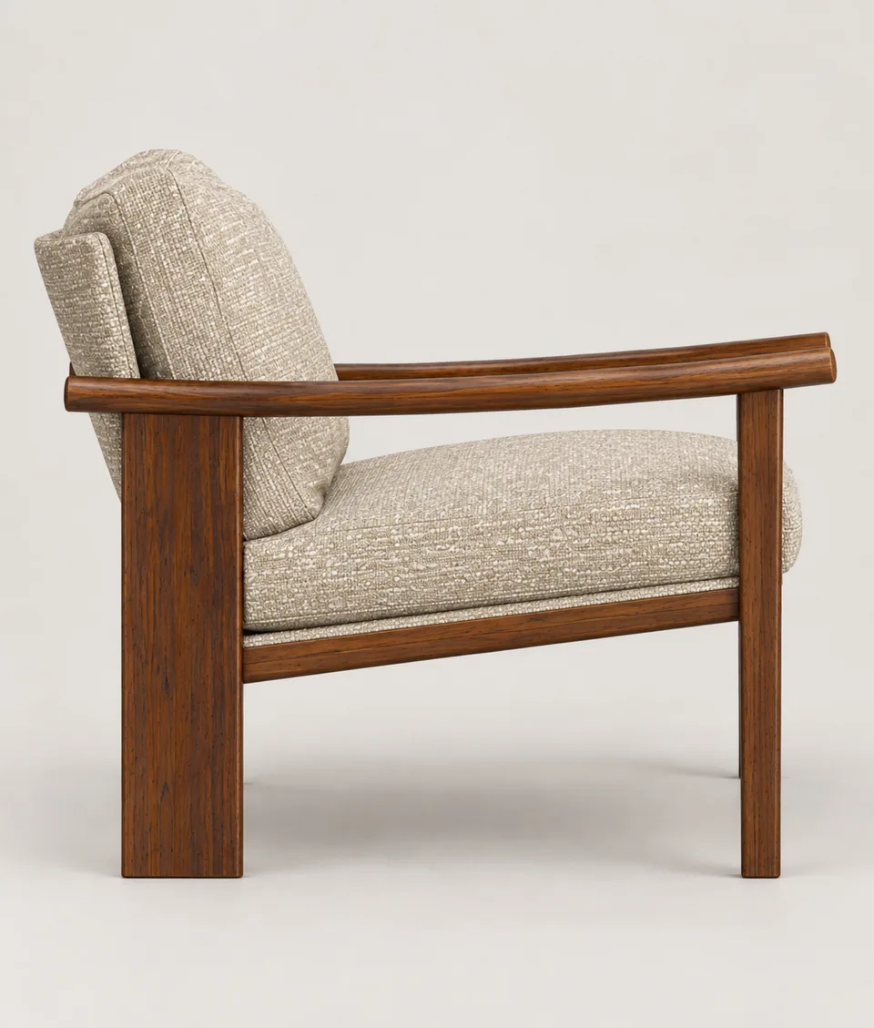 Mangeshi Arm Chair in sand bouclé with a dark-stained oak frame, side profile showing the curved arm and broad rear leg