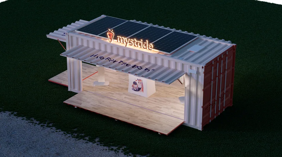 Aerial dusk render of the container booth with the rooftop sign glowing above the solar panels